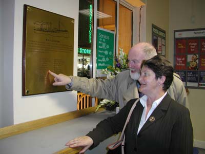 Philip Lecane pointing out to Marie Comiskey the name of her relative, Postal Sorter Matthew Brophy.